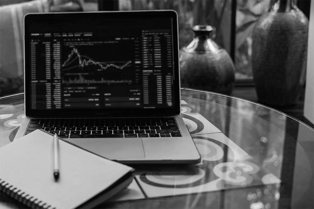 Laptop displaying cryptocurrency market data, used for blockchain investigation and tracking digital asset transactions